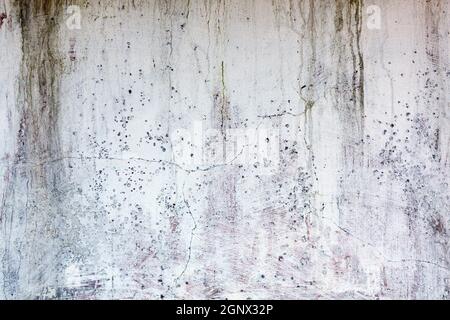 Old whitewashed weathered distressed cracked cement stone wall texture background Stock Photo
