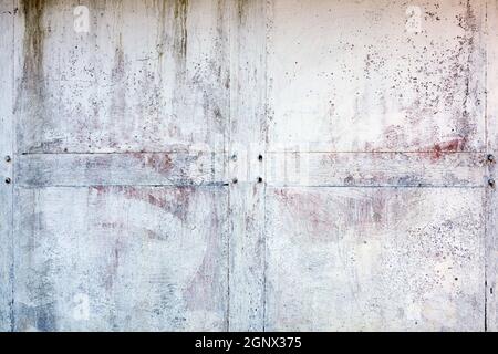 Old whitewashed weathered distressed cracked cement stone wall texture background Stock Photo