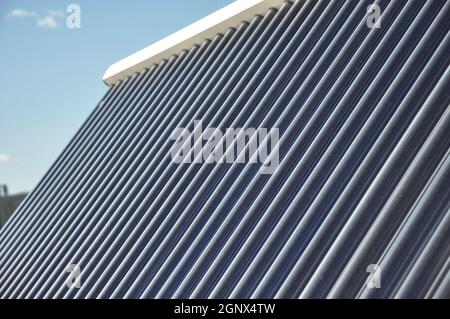 Close up on solar water panels heating glass tubes textured background. Stock Photo