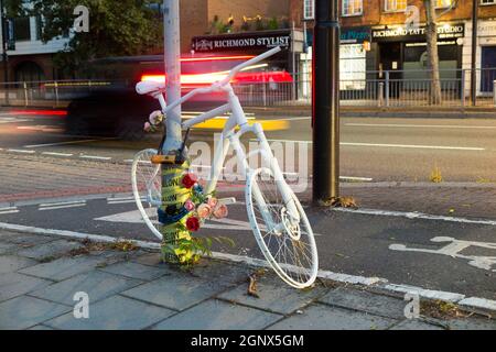 A cycle ghost bike (also referred to as ghostcycle or WhiteCycle) bicycle roadside memorial, where a cyclist was killed in Richmond, London UK. (127) Stock Photo