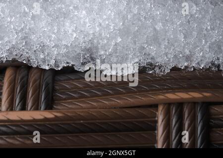 Thick frost or snow on textured plastic garden furniture. Full frame abstract image, from a super close up macro perspective. Cold winter weather Stock Photo