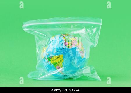 Planet earth in plastic bag - Concept of plastic pollution and ecology Stock Photo