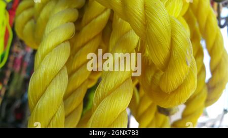 Closeup of bright color braided plastic ropes. Hanks or coil of