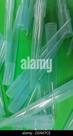 Close up view of micro litre tips on green floor sheet with empty holes. Reseach lab. tool for accurate measurement. Stock Photo