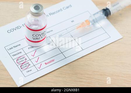 Vaccination record card of booster dose or third injection of covid-19 vaccination for high immunity against delta variant. Stock Photo