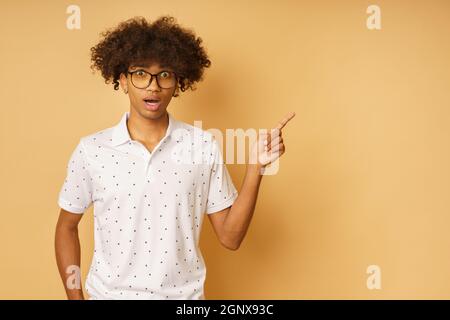 Amazed man with glasses indicates something with hand Stock Photo