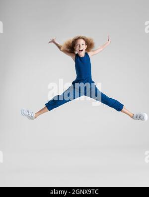 Little cute girl jumping high and flying in sky Stock Photo - Alamy