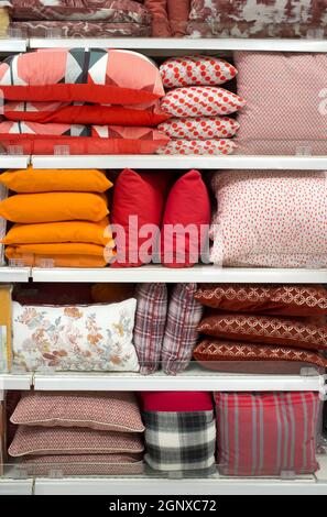 Colorful pillows and bed wear on shelves. Selective focus Stock Photo