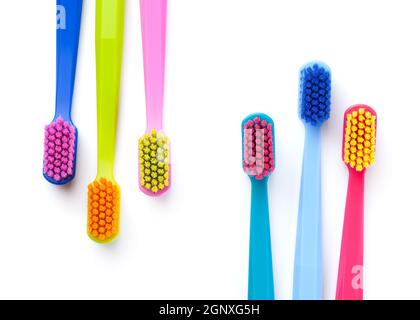 Colorful new toothbrushes isolated on white background. Top view Stock Photo