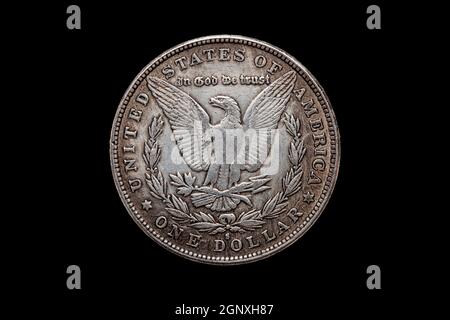 USA One Dollar Morgan Silver Coin replica dated 1880 with an image of a spread eagle on the reverse cut out and isolated on a black background, stock Stock Photo