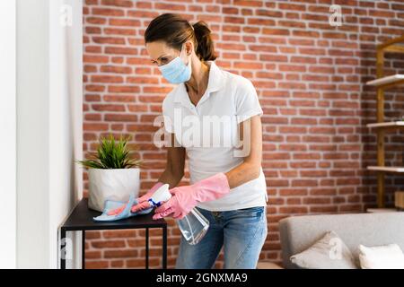 Living Room House Cleaning Service In Face Mask Stock Photo