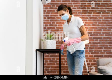 Living Room House Cleaning Service In Face Mask Stock Photo