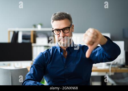 Man Giving Bad Feedback And Dislike Thumbs Down Stock Photo