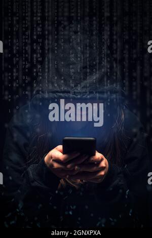 Hacker with cellphone. Young woman using dark web with smartphone. Stock Photo