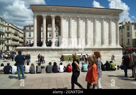 Nimes -  France - April 24 2011 : Historic Roman temple, the Maison Carree Perfectly preserved ancient monument  Summer day with tourists visiting the Stock Photo