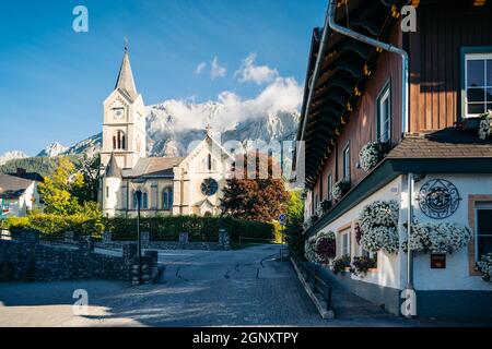 Protestant church in Ramsau am Dachstein with Dachstein mountain range towering in the back, Austria Stock Photo