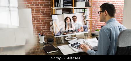 Financial Tax Advisor Looking At Invoice In Video Conference Stock Photo
