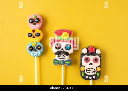 Candy skull lollipops on yellow background Stock Photo