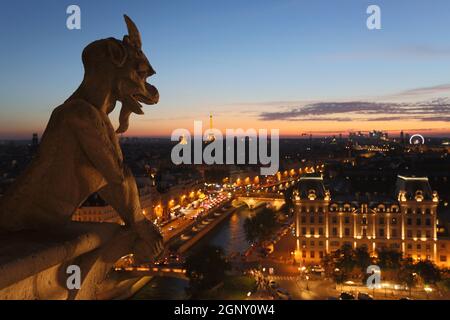 The Chimeras of Notre Dame watching the sunset in Paris Stock Photo