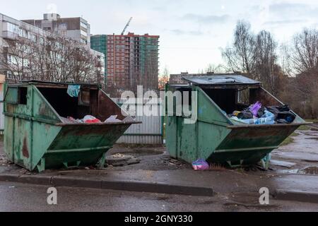 dirty garbage containers, dumpsters with household rubbish in a sleeping district of the city Stock Photo