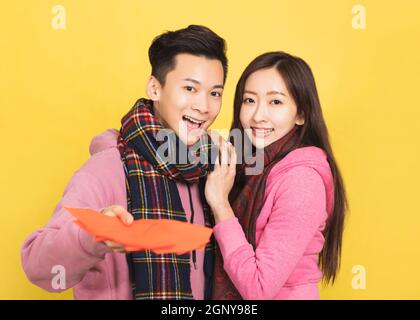 happy asian couple showing red envelpoe and celebrating chinese new year Stock Photo