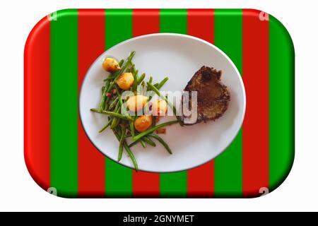 Fried beef liver with vegetables on a white plate on a green-red surface Stock Photo