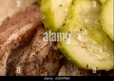 Thinly sliced homemade lard with pepper and chopped pickles close-up, selective focus Stock Photo