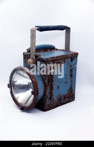 Old rusty blue railway lantern on white background. Stock Photo