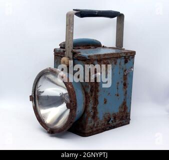 Old rusty blue railway lantern on white background. Stock Photo