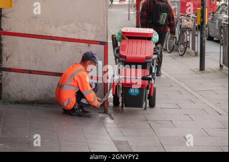 alamy stock photo man sweeping up street new york