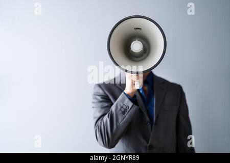 Man Making Megaphone Announcement. Warning Concept Speaker Stock Photo