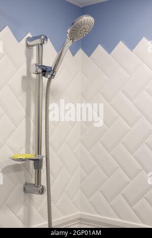 Modern shower on wall rail in modern white bathroom. Stock Photo