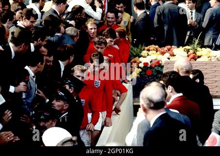File photo dated 30-07-1966 of The victorious England players walk down the steps from the Royal Box after being presented with the World Cup: (bottom to top) Bobby Moore, Geoff Hurst, Bobby Charlton, Roger Hunt, Martin Peters, Ray Wilson (hidden), Alan Ball, Jack Charlton, George Cohen, Nobby Stiles and Gordon Banks Issue date: Tuesday September 28, 2021. Stock Photo