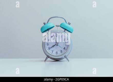 Retro styled white alarm clock, isolated and copy space Stock Photo
