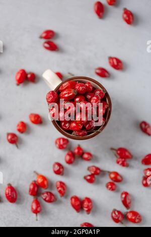 Medicinal plants and herbs. Rose hips berries on concrete background with copy space. Dried fruits for herbal teas and essential oils. Selective focus Stock Photo