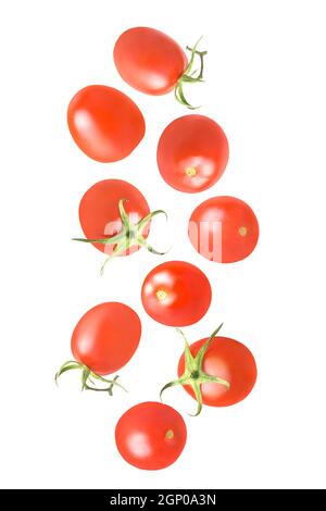 Isolated falling vegetables. Nine whole tomatoes in the air on white with clipping path as package design element. Full depth of field. Food levitatio Stock Photo