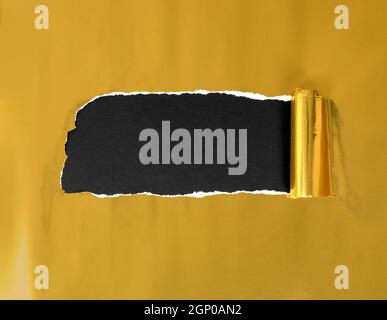 Gold Ripped Paper Shiny gold ripped torn paper against black background texture, copy ...