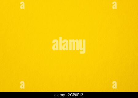 Blank yellow paper, rough yellow sheet as texture or background, bright, warm cardboard, top view, space for text Stock Photo