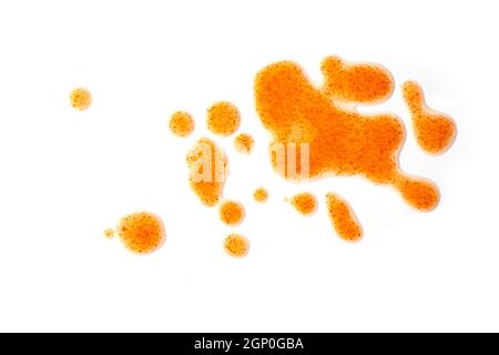 Red drops of chili sauce, close-up spots, splashes isolated on white background, top view Stock Photo