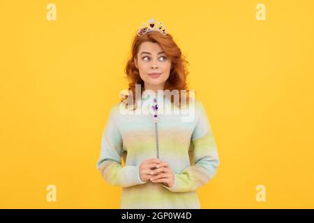 surprised redhead woman in queen crown with magic wand, magic Stock Photo