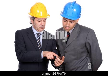 Two Engineers or Architects, on the phone, isolated in white background Stock Photo