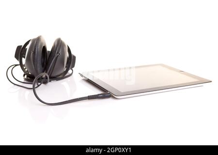 Headphones connected to a last generation tablet computer Stock Photo