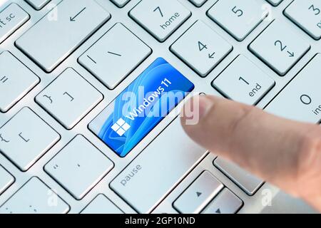 June 23, 2021. Barnaul, Russia. Close up of finger on keyboard button with Windows 11 logo A new operating system update from Microsoft Stock Photo