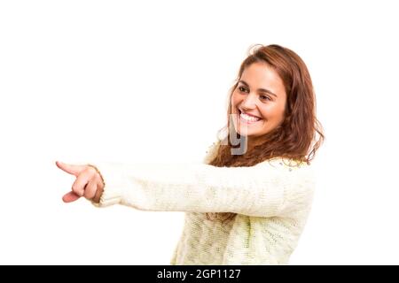 A beautiful woman pointing to something, isolated over a white background Stock Photo