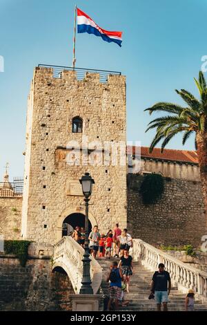 Korcula Croatia - 10 August 2021: Main entrance in the old town of Korcula with walking people. Stock Photo