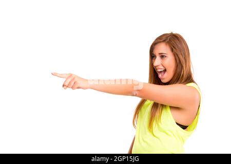 A beautiful teenager pointing to something, isolated over a white background Stock Photo