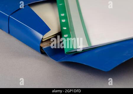 Blue document case on a gray background. Open case with folders Stock Photo