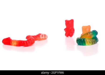Snakes fighting with gummy bears, isolated on white Stock Photo