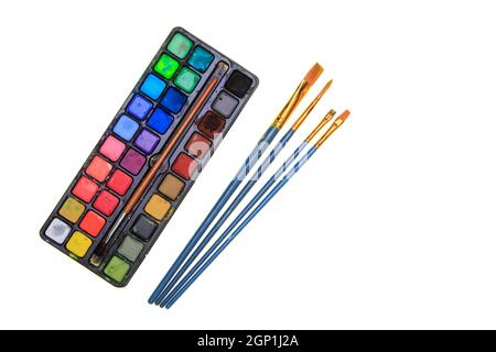 Pallet of water colour paints and brushes isolated on a white background Stock Photo