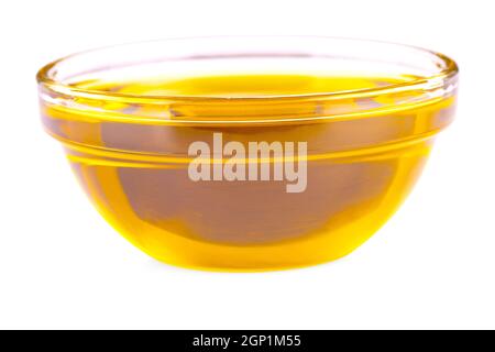Pouring cooking oil a small glass cup isolated on white background Stock Photo